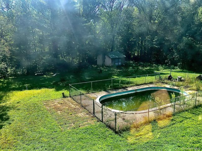 View of swimming pool with a storage shed and an outbuilding | Image 14