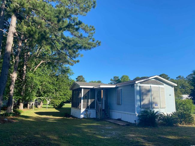 Rear view of house featuring a sunroom and a lawn | Image 5
