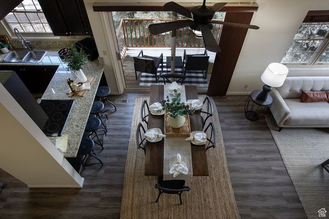 Dining room featuring baseboards, healthy amount of natural light, a ceiling fan, and dark wood-style flooring | Image 4