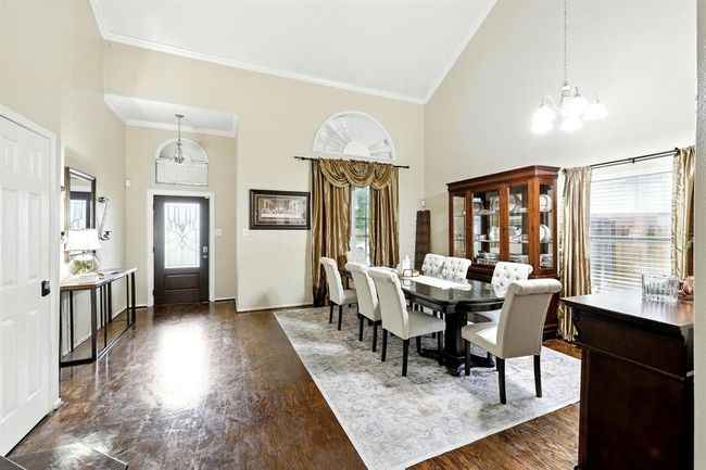 Impressive formal dining space located just off the foyer, showcasing vaulted ceilings and a welcoming flow into the home. | Image 5