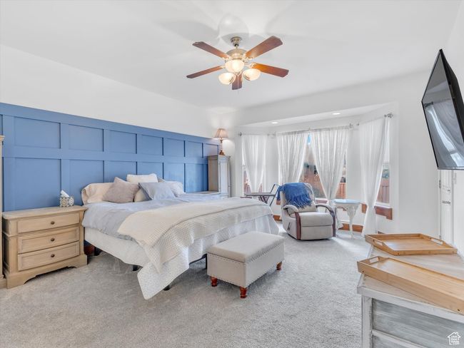 Bedroom with carpet floors, ceiling fan, and a decorative wall | Image 17