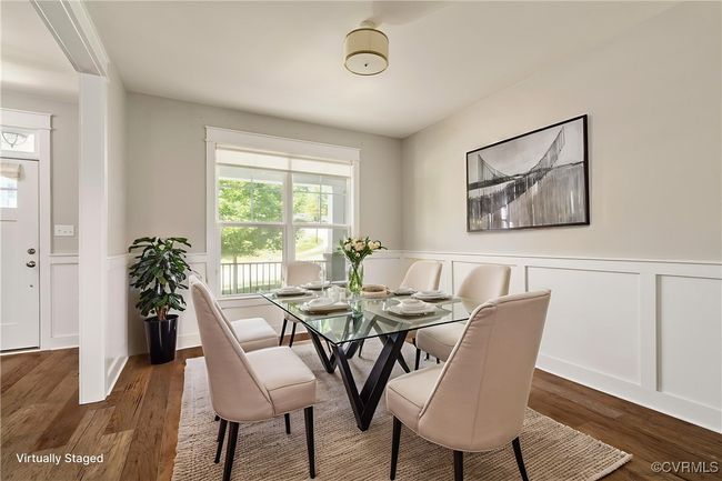 Dining area featuring healthy amount of natural light, wood finished floors, wainscoting, and a decorative wall | Image 4