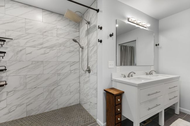 Large walk-in shower and double vanities. | Image 28