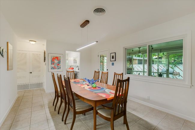 Dining room featuring light tile patterned floors and baseboards | Image 7