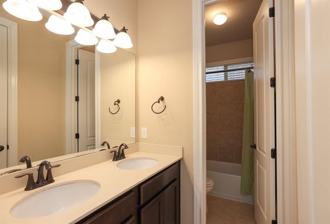 Double sinks and private bathing area on main floor. | Image 33