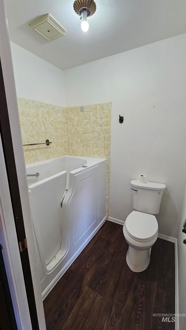 Bathroom with a garden tub and wood finished floors | Image 17