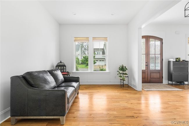 Living area with light wood-type flooring and baseboards | Image 4