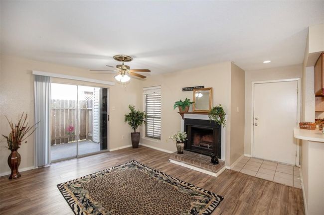 A sliding glass door off the family room leads to a private patio, perfect for enjoying your morning coffee or unwinding in the evening. | Image 8