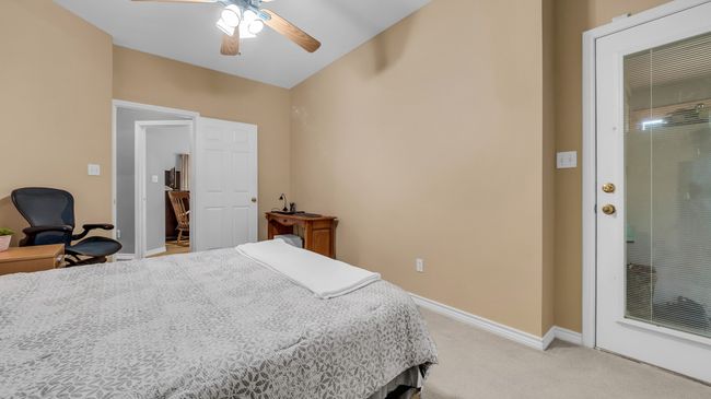 Bedroom featuring light colored carpet, baseboards, and a ceiling fan | Image 16