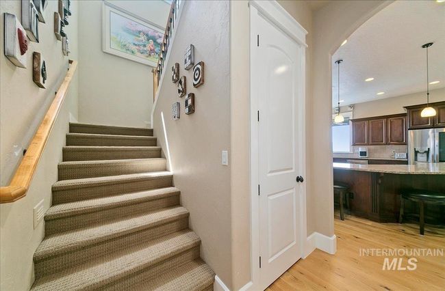 Stairway with wood finished floors, arched walkways, and recessed lighting | Image 29