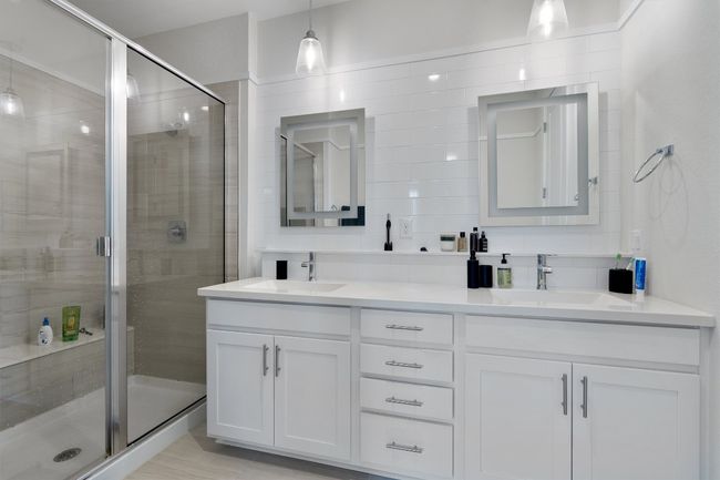 Bathroom featuring double vanity and a stall shower | Image 30