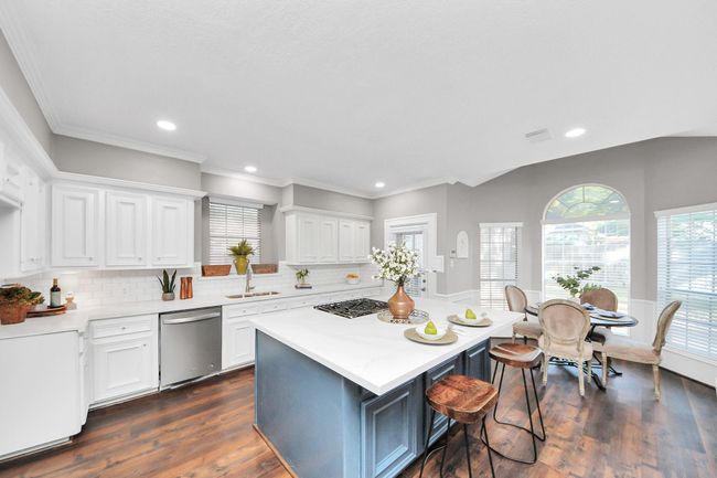 Updated lighting with new appliances, quartz countertops and subway tile backsplash. | Image 11