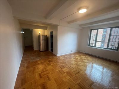 Spare room with beamed ceiling and light parquet floors | Image 3