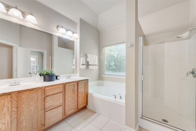 Dual vanity in the primary bath as well as a soaking tub and separate​​‌​​​​‌​​‌‌​‌‌​​​‌‌​​‌‌​‌​​​​​‌ shower. | Image 15