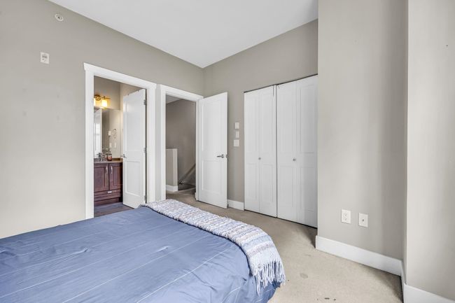 Carpeted bedroom with baseboards, a closet, and ensuite bathroom | Image 18