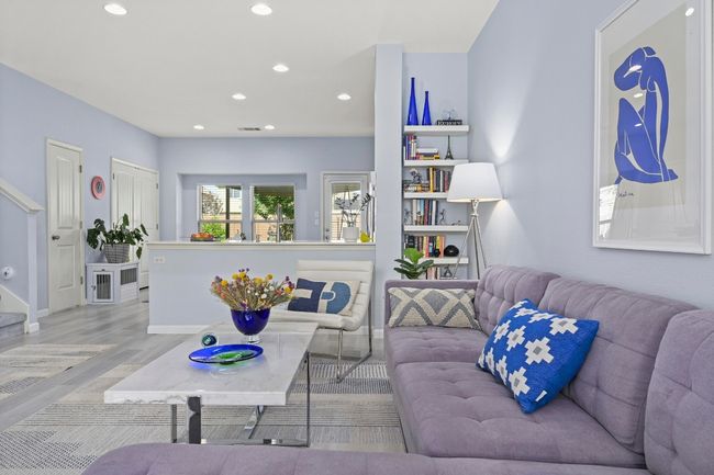 Living room featuring baseboards, stairs, wood finished floors, and recessed lighting | Image 10