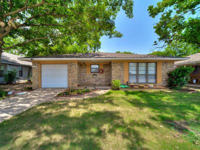 Ranch-style brick home with nice landscaping and mature trees! | Image 1