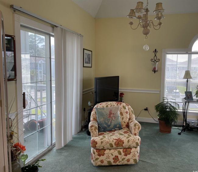 Sitting room with carpet flooring, a chandelier, and vaulted ceiling | Image 7
