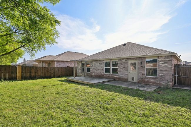 Back of house featuring a patio, a fenced backyard, brick siding, a shingled roof, and a lawn | Image 30