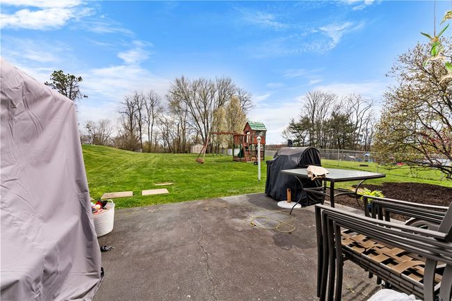 The patio is accessed from the kitchen/dining area, lovely area to grill offering privacy with a nice privacy fence. Enjoy the warm weather this summer. Play set is conveying as is. | Image 18