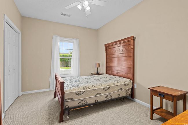 Bedroom with carpet flooring, baseboards, and ceiling fan | Image 6