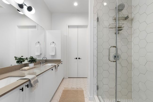 Main bathroom with double vanity sinks, walk-in shower, and huge walk-in closet | Image 5