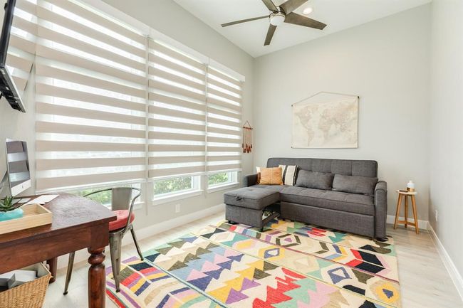 Transform your work routine into ahaven of productivity and comfort inthis thoughtfully designed homeoffice. Located behind private Frenchdoors, the room features large windows that allow innatural light. | Image 7