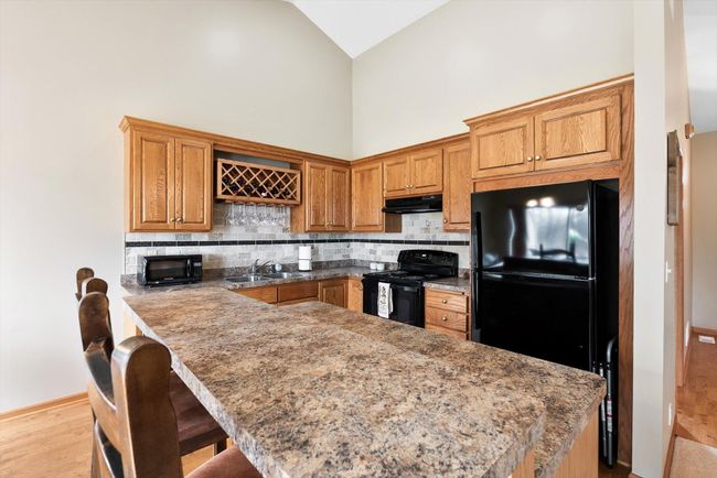 Large kitchen island with room for bar-height stools—perfect for casual dining or entertaining. | Image 11