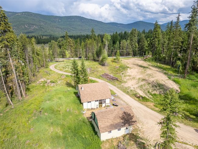 View of subject property featuring a heavily wooded area and a mountainous background | Image 21