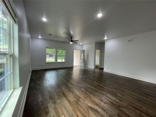 Empty room featuring ceiling fan, dark wood finished floors, recessed lighting, and baseboards | Image 11