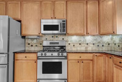 A closer view of just some of the many cabinets you will find in this kitchen - some 42 inch cabinets, lazy susan, and many with pullout shelving. | Image 3