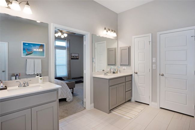 Ensuite bathroom featuring two vanities and a ceiling fan | Image 18