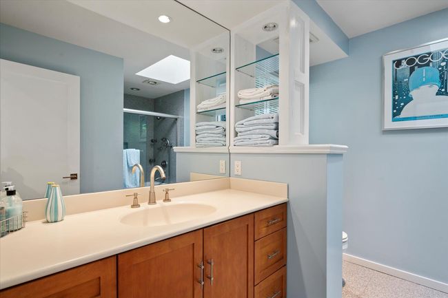 Bathroom featuring vanity, a stall shower, and a skylight | Image 16