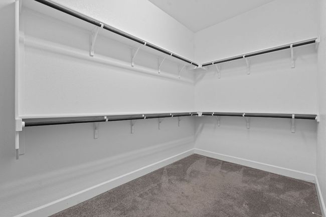 the spacious walk-in closet is the only space in the home with carpeting, which is nice and cozy underfoot. | Image 24