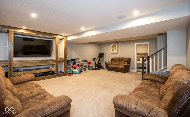 Basement equipped with stereo speakers, built-in shelves | Image 27