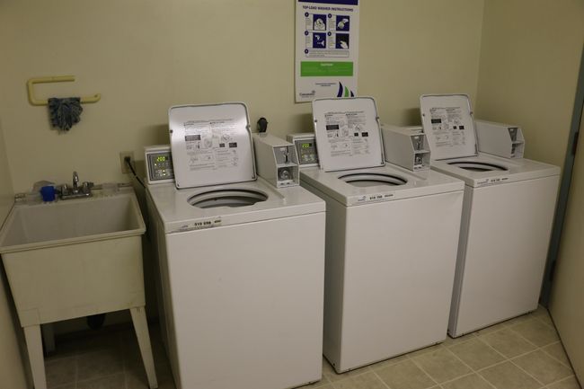Shared laundry room featuring washing machine and dryer and light tile patterned floors | Image 19