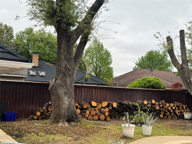 View of side of home featuring a chimney and fence | Image 5