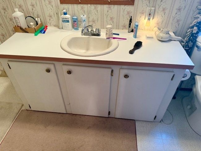 Bathroom with carpet, wallpapered walls, and vanity | Image 26