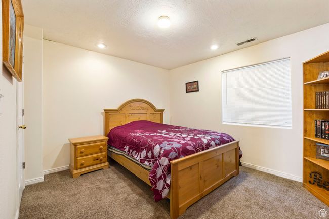 Carpeted bedroom featuring baseboards, visible vents, and recessed lighting | Image 30