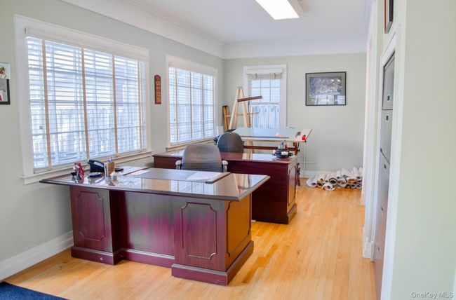Office featuring light wood-style floors, ornamental molding, and baseboards | Image 4
