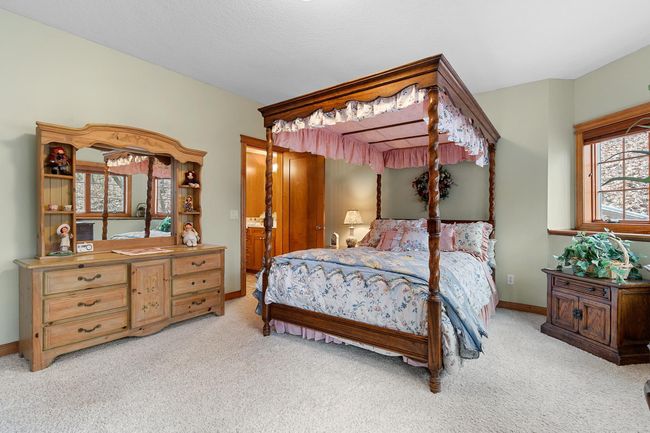 Lower-level second bedroom with full bath and walk-in closet. View toward woods, hot tub and fenced area. Wired LAN available. | Image 56