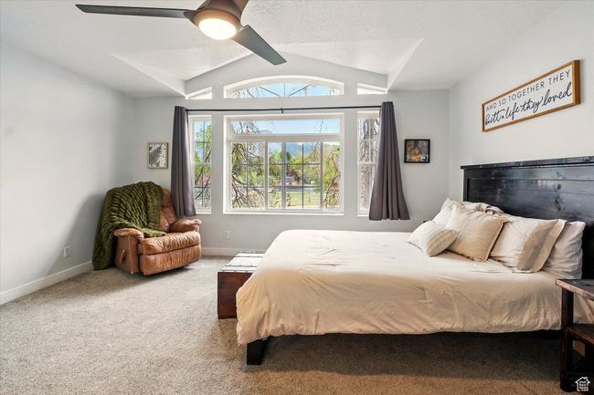 Bedroom with carpet flooring, vaulted ceiling, and ceiling fan | Image 41