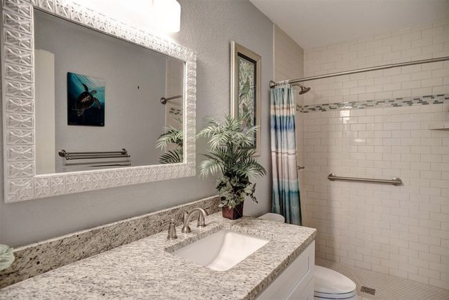 Bathroom featuring a tile shower and vanity | Image 21