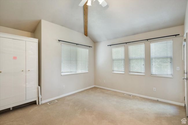 Bedroom with light colored carpet and a ceiling fan | Image 17