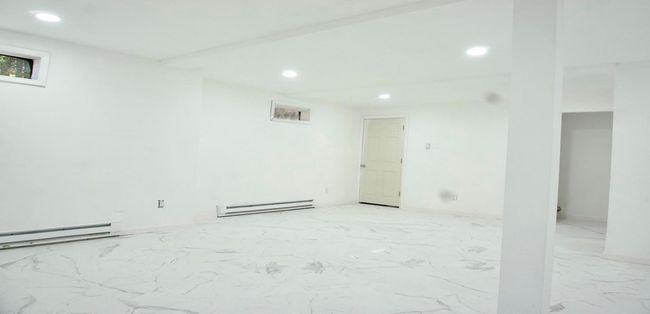 Empty room featuring baseboard heating, recessed lighting, and marble finish floor | Image 40