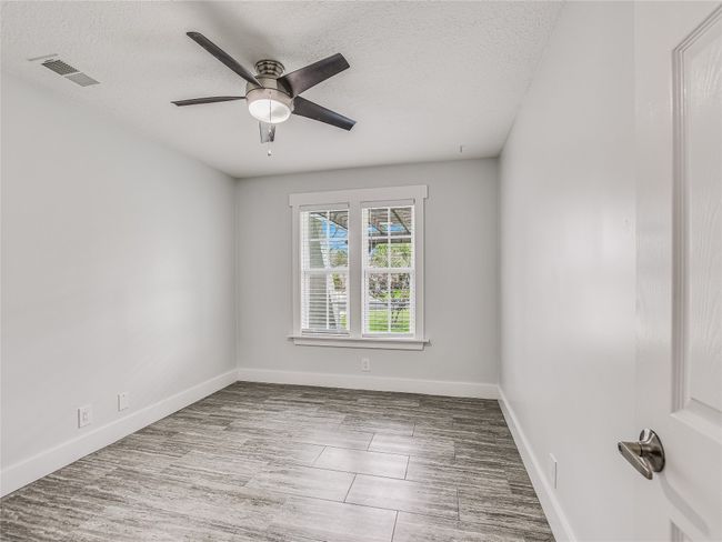 Unfurnished room with a ceiling fan, visible vents, and a textured ceiling | Image 14