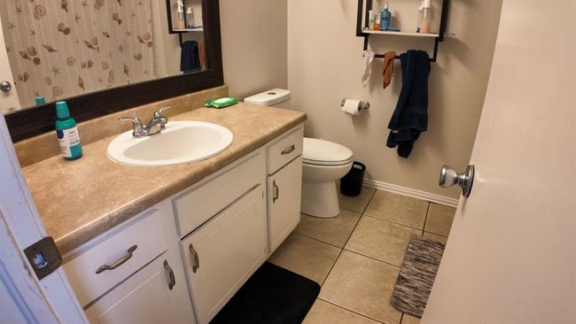 Bathroom featuring vanity, tile patterned floors, and a shower with shower curtain | Image 7