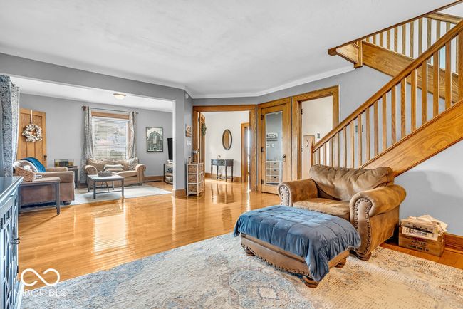 living room with wood finished floors and stairs | Image 19