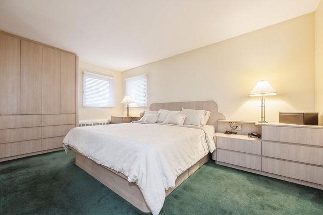 Bedroom featuring radiator and dark carpet | Image 12