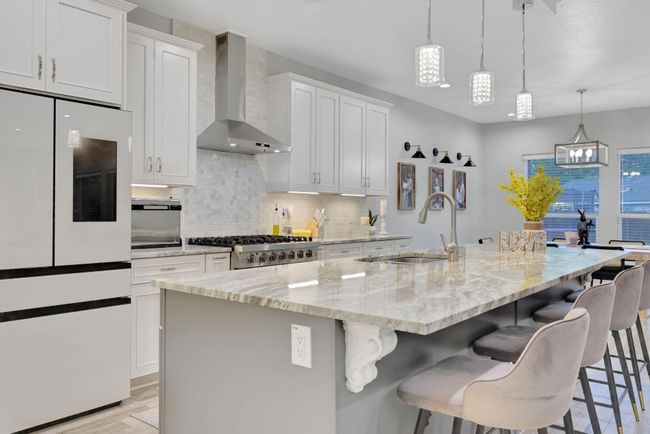 Elegant kitchen with premium appliances and a spacious island, ideal for family gatherings. | Image 18
